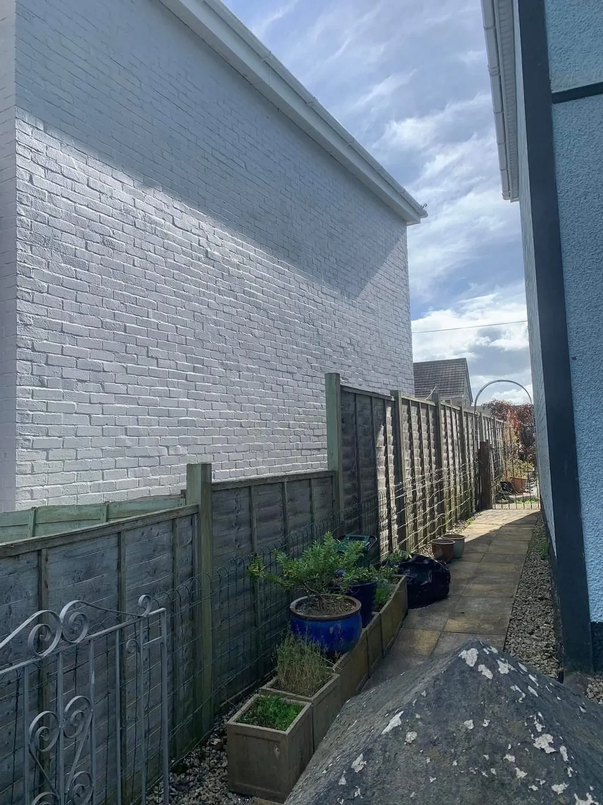 Freshly painted brick wall after preparation and masonry paint in Perranporth